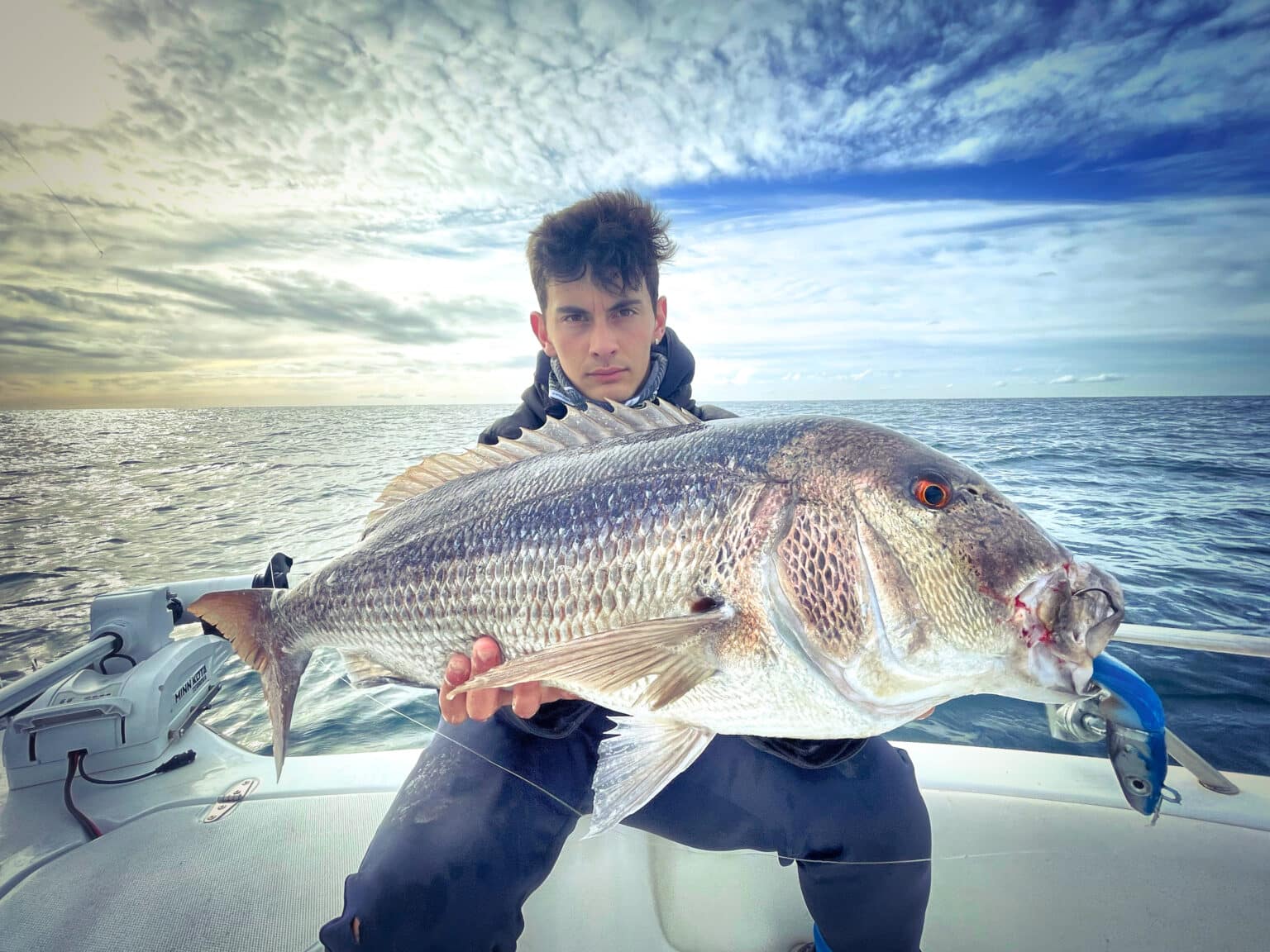 Angler with a large dentex caught on a fishing trip from Palamós