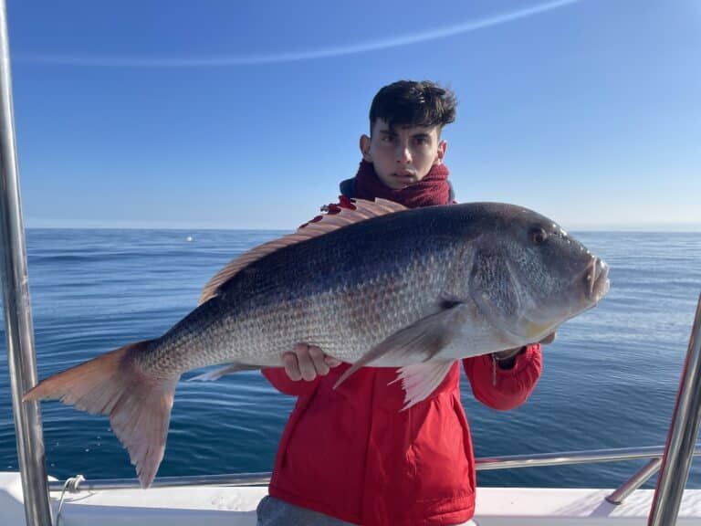 Young angler with his catch on an inshore fishing trip